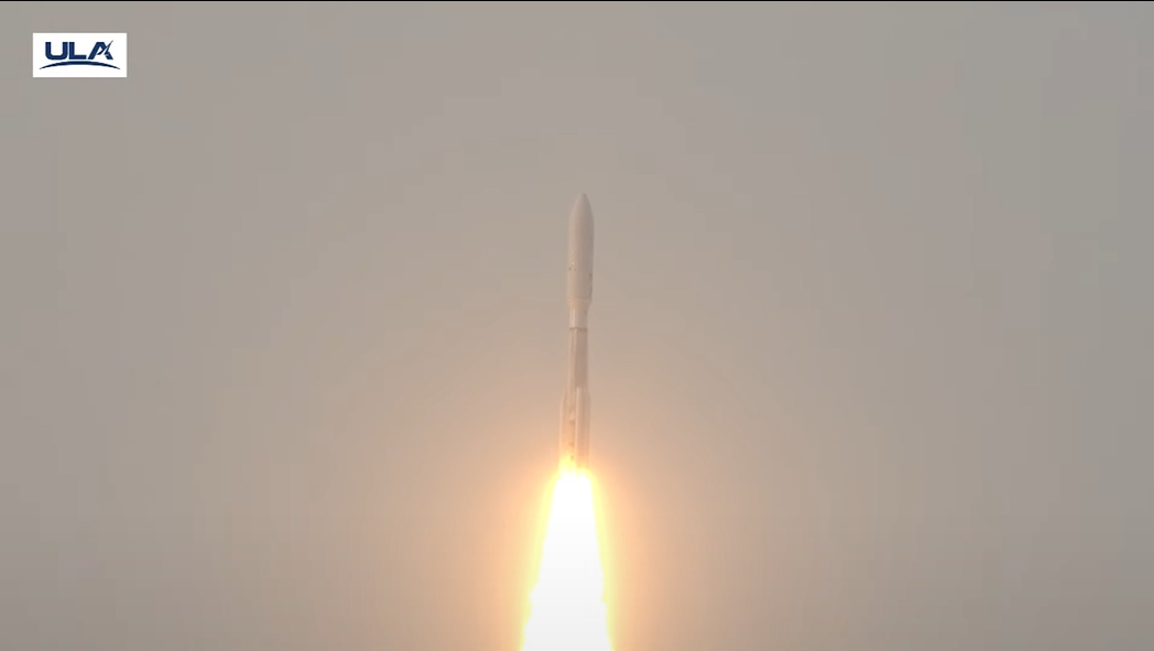 a rocket blasts off against a hazy sky