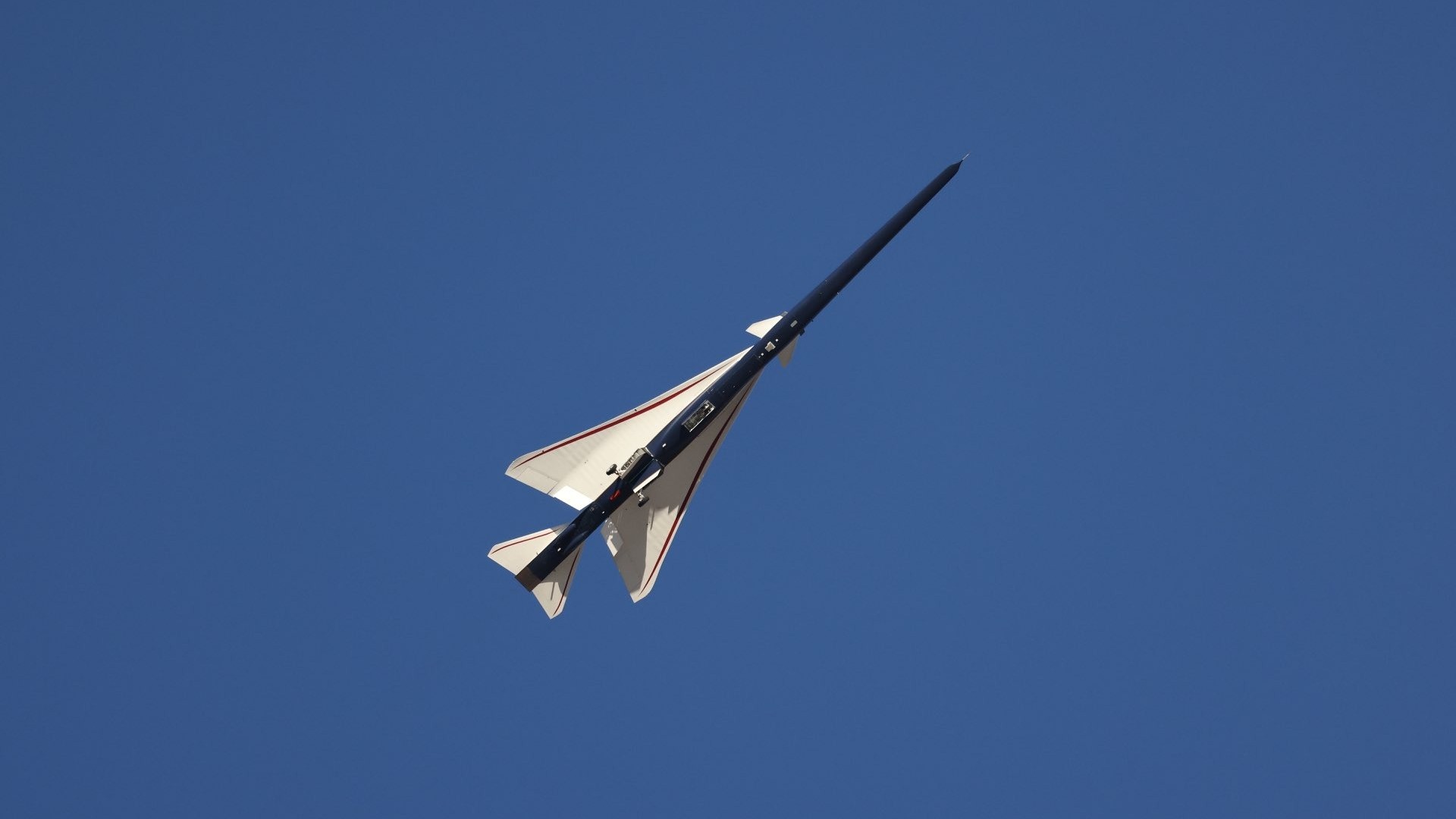 an elongated blue-and-white jet in flight